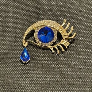 Elegant Gold and Blue Eye Brooch